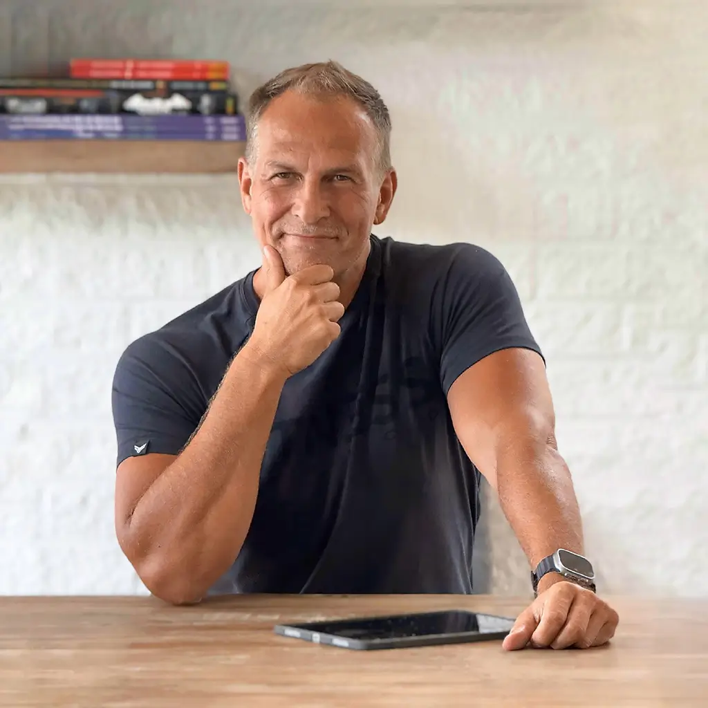 Achim Loobes am Tisch mit iPad – Entwickler von VigiGym, zwischen Technik und Charakter